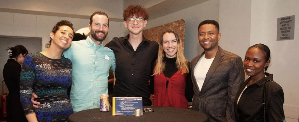 Several UCSF community members gathered around a cocktail table at a planned event