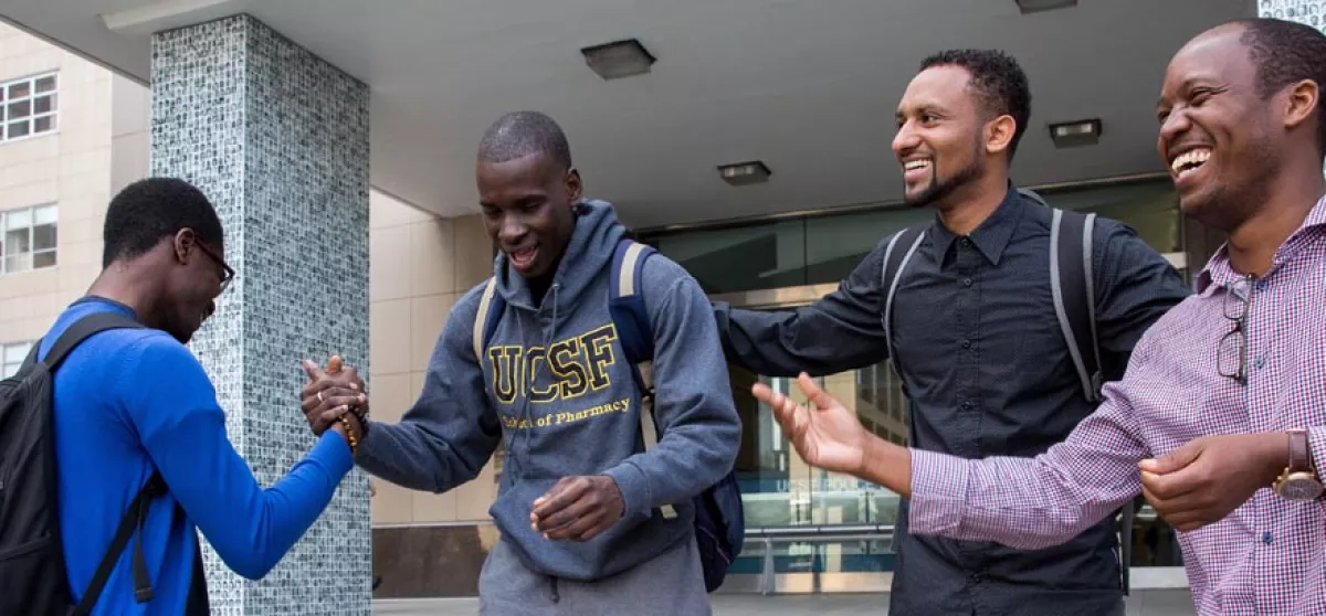 Several UCSF community members greet each other on the steps of the School of Pharmacy, Parnasus campus.