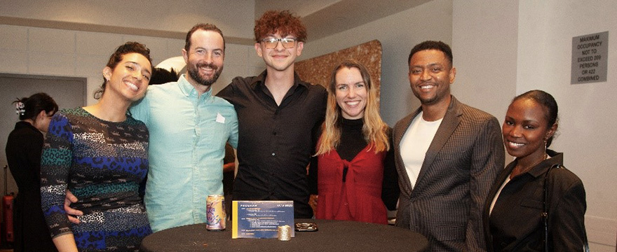 Several UCSF community members gathered around a cocktail table at a planned event
